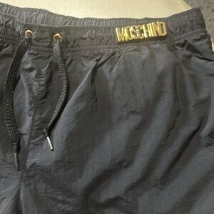 Moschino swim shorts with gold emblem